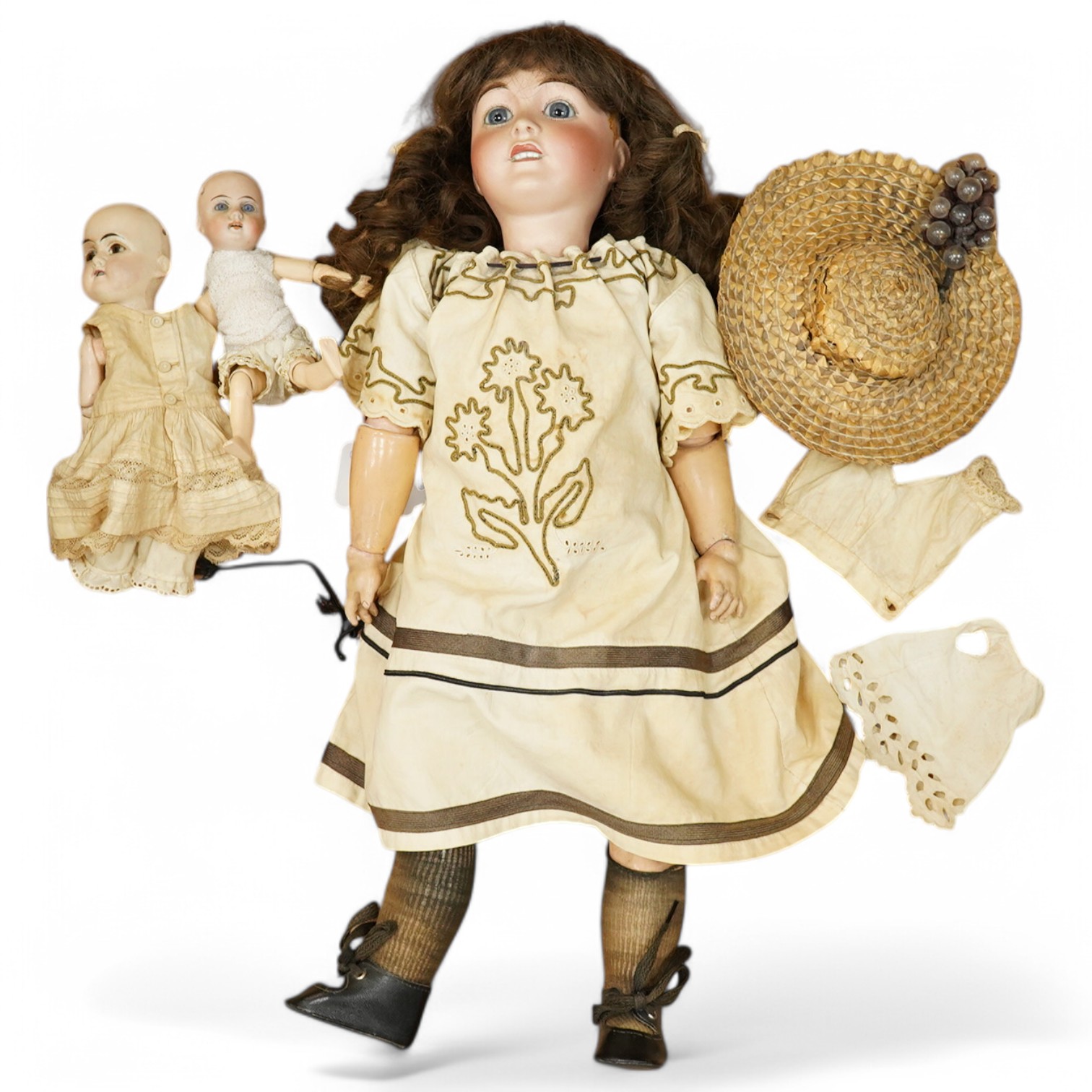 An Al & Cie, Ed Tasson Limoges bisque doll, with fixed glass eyes, open mouth and pierced ears, jointed composition body, a a small French bisque doll, stamped SG, and a German painted bisque doll, Limoges 54cm. Conditio